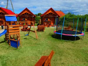a playground with a trampoline in the grass at PRZYSTAŃ CISZY in Jantar
