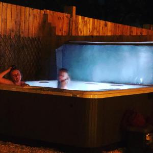 two people are in a bathtub in at Nellies Shed, Wolds Way Holiday Cottages, 3 bed spacious cottage in Cottingham
