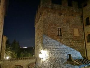 
a building with a clock on the side of it at Castel Pietraio in Monteriggioni
