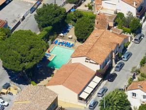 an overhead view of a house with a swimming pool at Hôtel Lou Paouvadou in Sainte-Maxime
