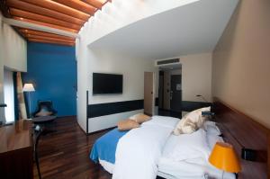 a bedroom with a large bed with a blue wall at Central Plaza in Zurich
