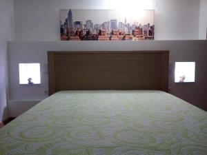 a bedroom with a bed with a view of a city at Casa Ferreira in Vila Chã