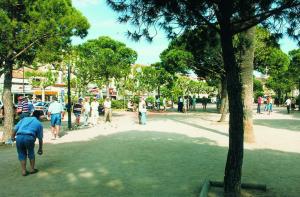 a group of people walking around in a park at Hôtel Lou Paouvadou in Sainte-Maxime
