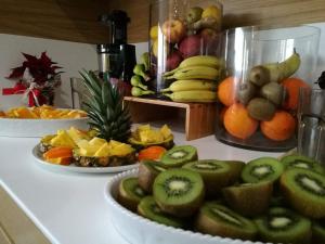 a table with plates of fruit on a counter at Alma di Alghero Hotel in Alghero