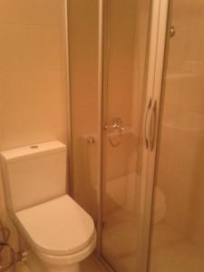 a bathroom with a toilet and a glass shower at Melaike Hotel in Foça +70 photos