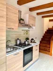 a kitchen with two pots and a stove top oven at Sweet Home in Francavilla di Sicilia