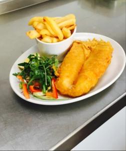 a plate of food with a fish and french fries at Green Tree Hotel in Peebles
