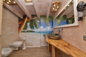 a bathroom with a sink and a toilet and a window at Attico da Maria in Polpenazze del Garda +21 photos