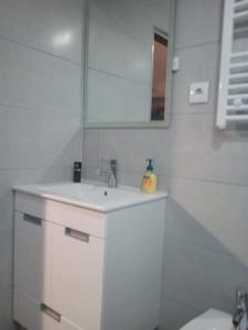 a white bathroom with a sink and a mirror at Casa Ferreira in Vila Chã +27 photos