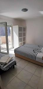 ein Schlafzimmer mit einem Bett und einem Stuhl darin in der Unterkunft Apartments Nika's View in Vodice