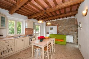 a kitchen with a table and a green couch at Palazzina Panorama in Massa Marittima
