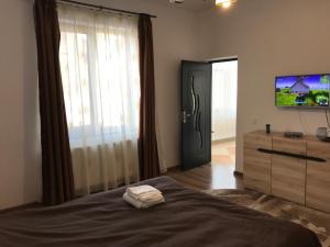 1 dormitorio con 1 cama, TV y vestidor en Casa Pricas, en Moieciu de Jos
