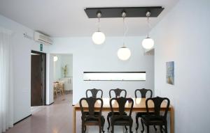 a dining room with a table and eight chairs at Villa Bamboo in Maleme