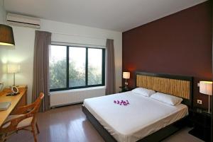 a bedroom with a large bed with flowers on it at Villa Bamboo in Maleme