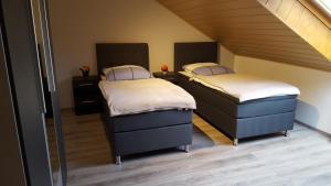 two twin beds in a room with a attic at Zeit(t)raum Mandy in Brandy in Waldsolms