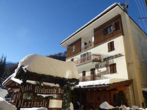 a building with snow on top of it at Albergo Nazionale in Vernante