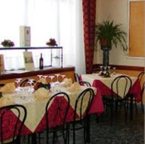 a dining room with a table and chairs and a table and chairsktop at Hotel Altavilla in Montefiascone