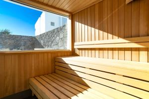a wooden sauna with a window in it at Hotel Lava Beach in Puerto del Carmen