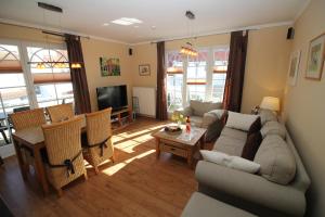 a living room with a couch and a table at Fewo Anna in Zingst