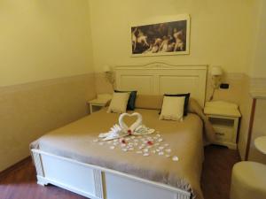 a bed with a white bedspread and pillows on top of it at Bed & Breakfast Medea in Naples