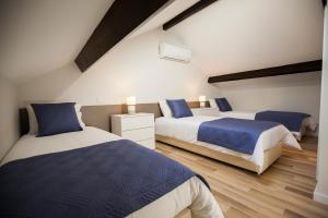 a bedroom with two beds with blue and white at OportoWaves in Matosinhos
