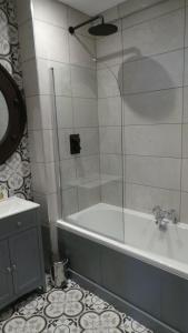 a bathroom with a shower and a tub and a sink at The Little Inn at Grasmere in Grasmere