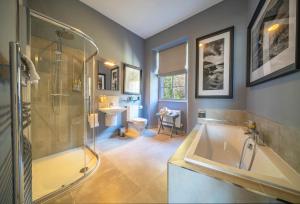 ein Badezimmer mit einer Dusche, einer Badewanne und einem Waschbecken in der Unterkunft Giles Norman Gallery & Townhouse in Kinsale