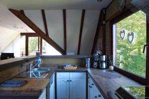 a kitchen with a sink and a large window at Ferienwohnung,Über Tage in Bochum