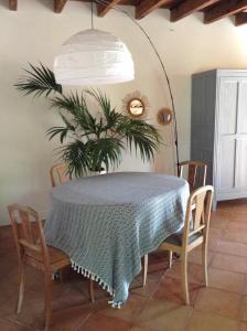 a dining room table with a plant on the wall at Garros in Fronsac