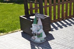 a statue of a gnome sitting in a box at Fazenda do Medronhal in Montemor-o-Novo