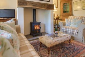 a living room with a wood stove in a room at Middle Cottage Southlands Farm in Gunnerton