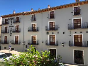 a white building with windows and balconies at Hotel Rey Don Jaime in Morella