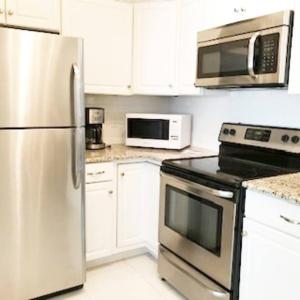 a kitchen with a stainless steel refrigerator and microwave at Boardwalk Front 1 st Floor in Atlantic City