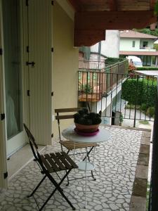 una mesa y sillas en un patio con una planta en B&B Il Noce alla Finestra, en Roe