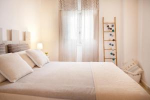 Ένα ή περισσότερα κρεβάτια σε δωμάτιο στο TorreParadiso Holidays