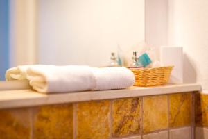 a towel and a basket on a counter in a bathroom at TorreParadiso Holidays in Polignano a Mare