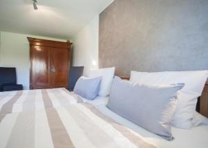 a bedroom with a large bed with white pillows at Ferienwohnung Mia in Winterberg