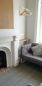 a living room with a couch and a fireplace at Bunkhouse Bournemouth in Bournemouth