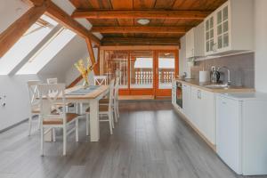 a kitchen and dining room with a table and chairs at Apartment Krnicar in Zgornje Gorje +28 photos