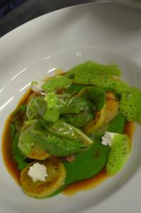 a plate of food with green vegetables and sauce at Ansitz Goller in Rasun di Sopra