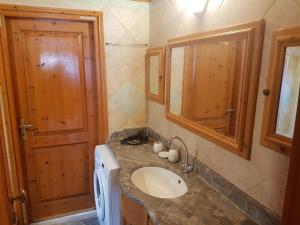 
a bathroom with a sink, mirror, and toilet at CorfuGrace in Sidari
