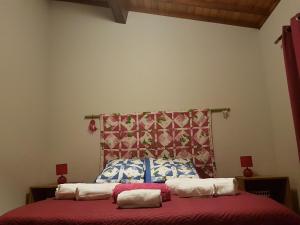 a bedroom with a bed with two pillows on it at Our relaxing holiday home in Mosteiros