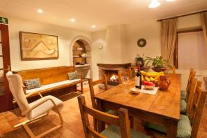 a living room with a table and a fireplace at La Pausa Rural & Wellness in Santa Greu del Jutglar