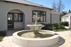 a fountain in front of a house at Forest Haven in Johannesburg