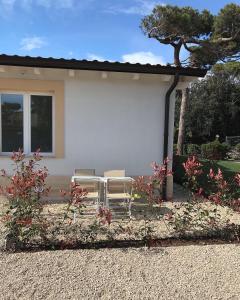 two chairs sitting in front of a house at Il Miraggio in Fregene