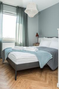 Posteľ alebo postele v izbe v ubytovaní Apartament przy Zachodnim