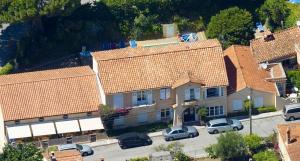 an aerial view of a house with cars parked in a parking lot at Hôtel Lou Paouvadou in Sainte-Maxime