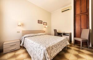 Postel nebo postele na pokoji v ubytování Hotel Aurelia