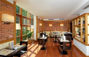 a restaurant with tables and chairs and a brick wall at Hotel Master in Brescia