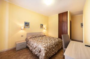 Postel nebo postele na pokoji v ubytování Hotel Aurelia